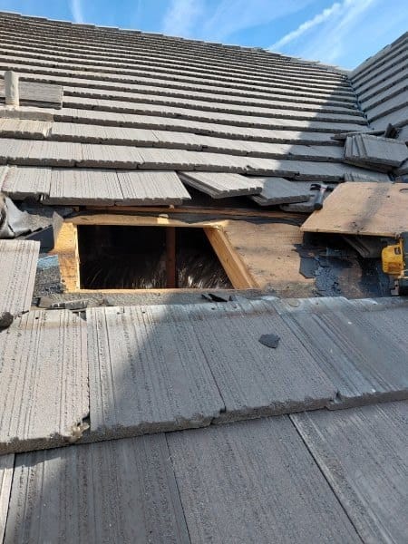 Concrete tile roof section removed for repair, exposing the roof decking underneath
